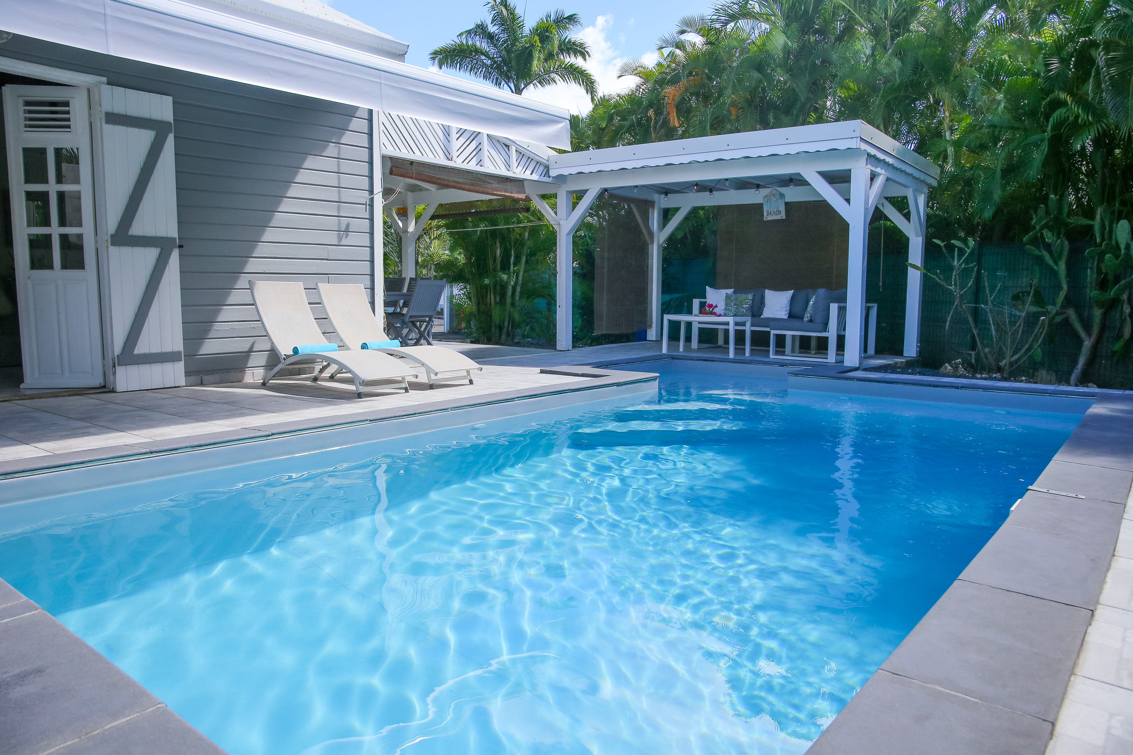 Piscine au sel, bain de soleil et salon d’extérieur abrité sous la pergola de la Villa Bahia