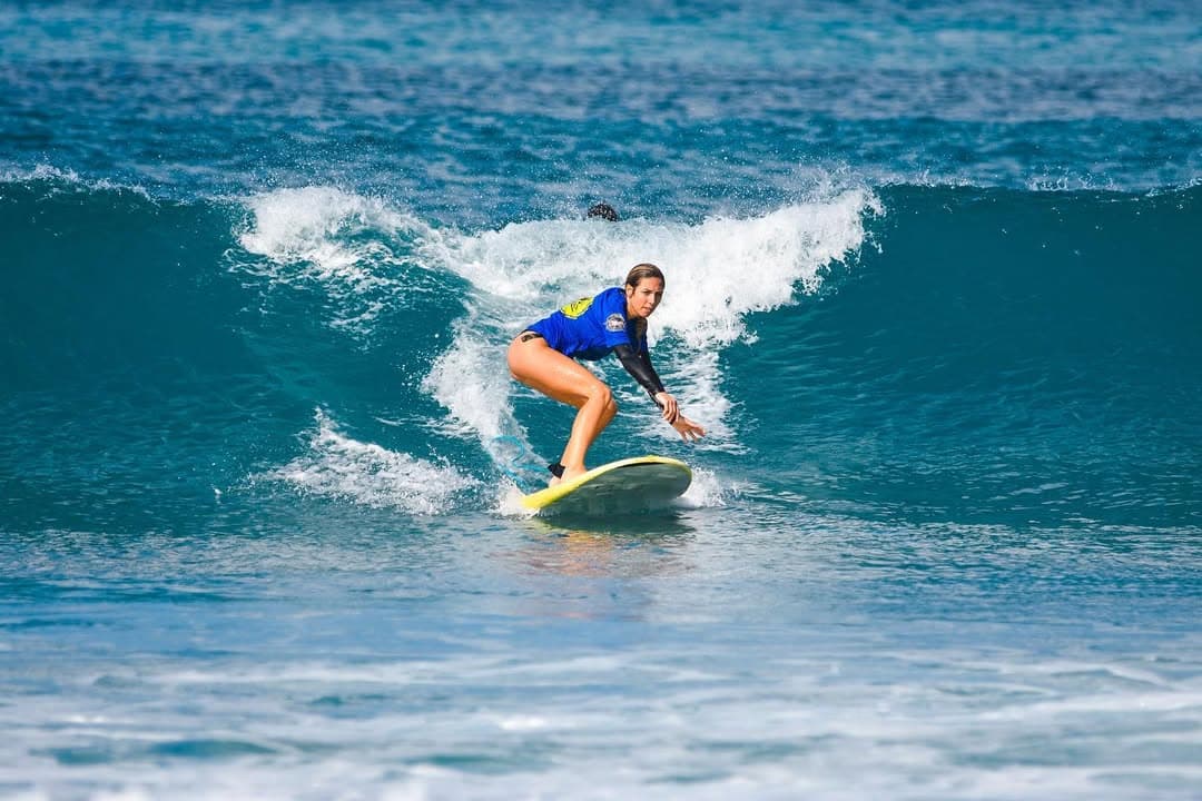 Une surfeuse prenant une vague du spot du Helleux, à cinq minutes de la Villa Alizé
